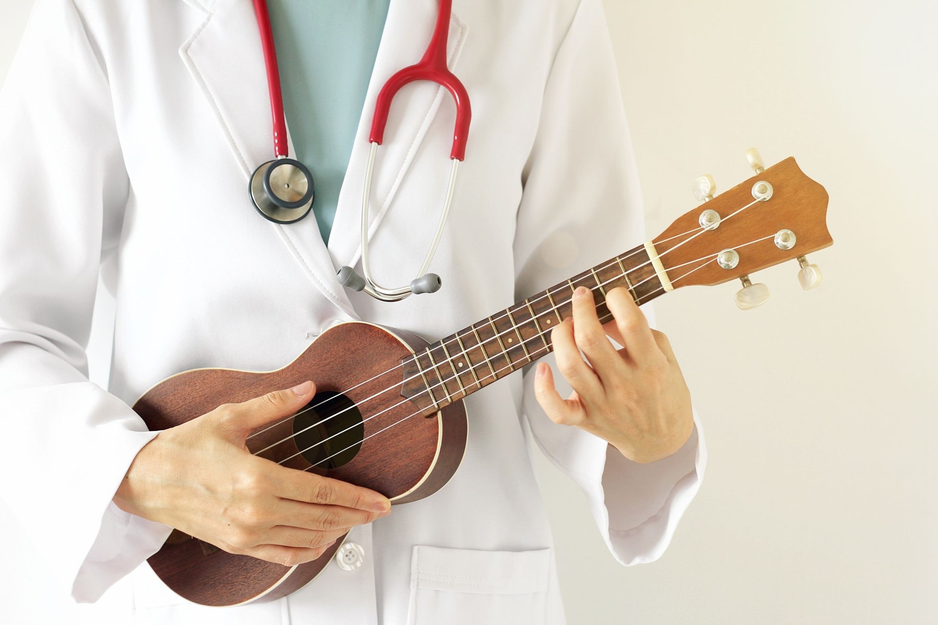 Doctor playing ukulele, Music therapy concept.